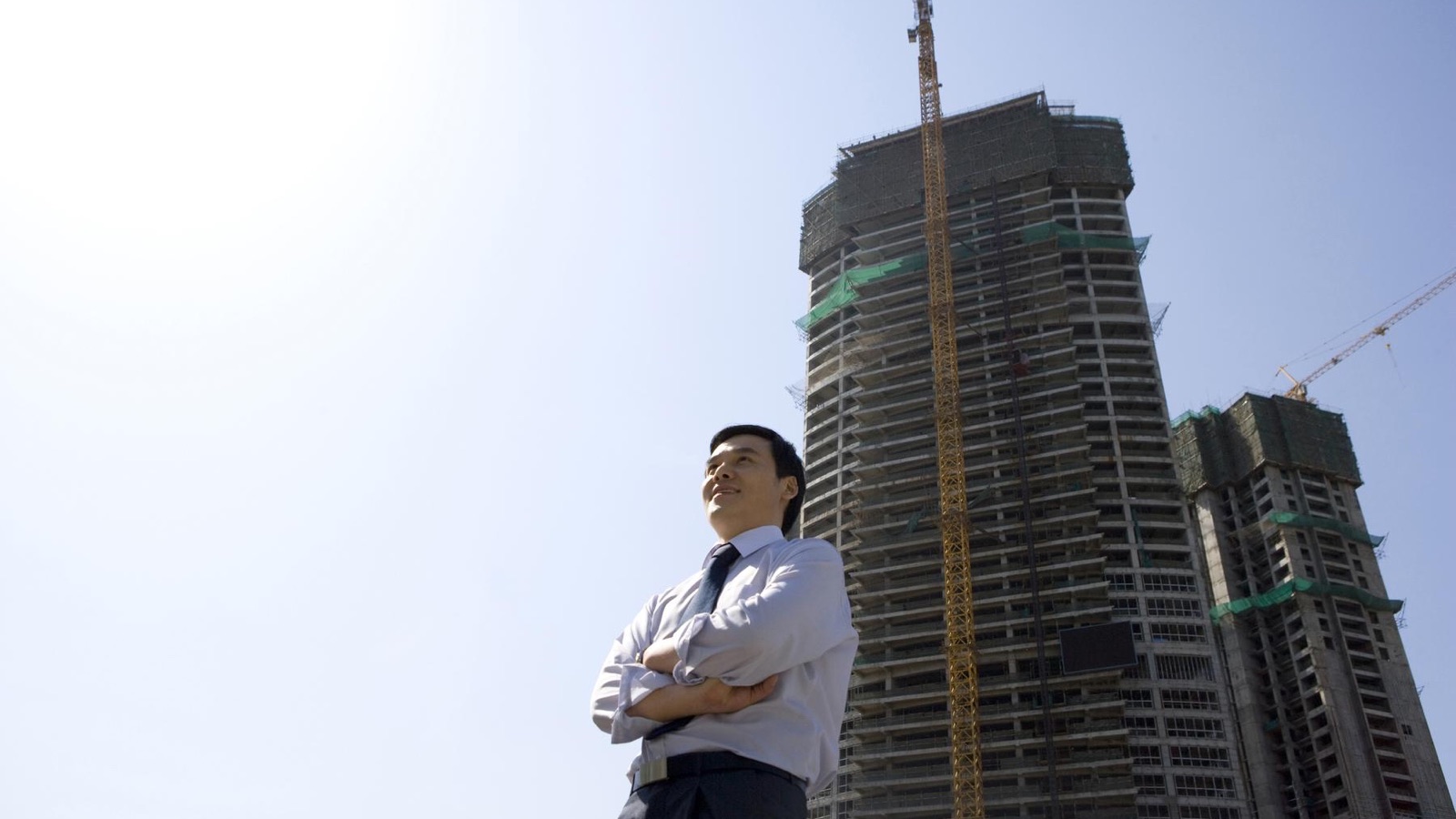 Construction professional against a high-rise skyline