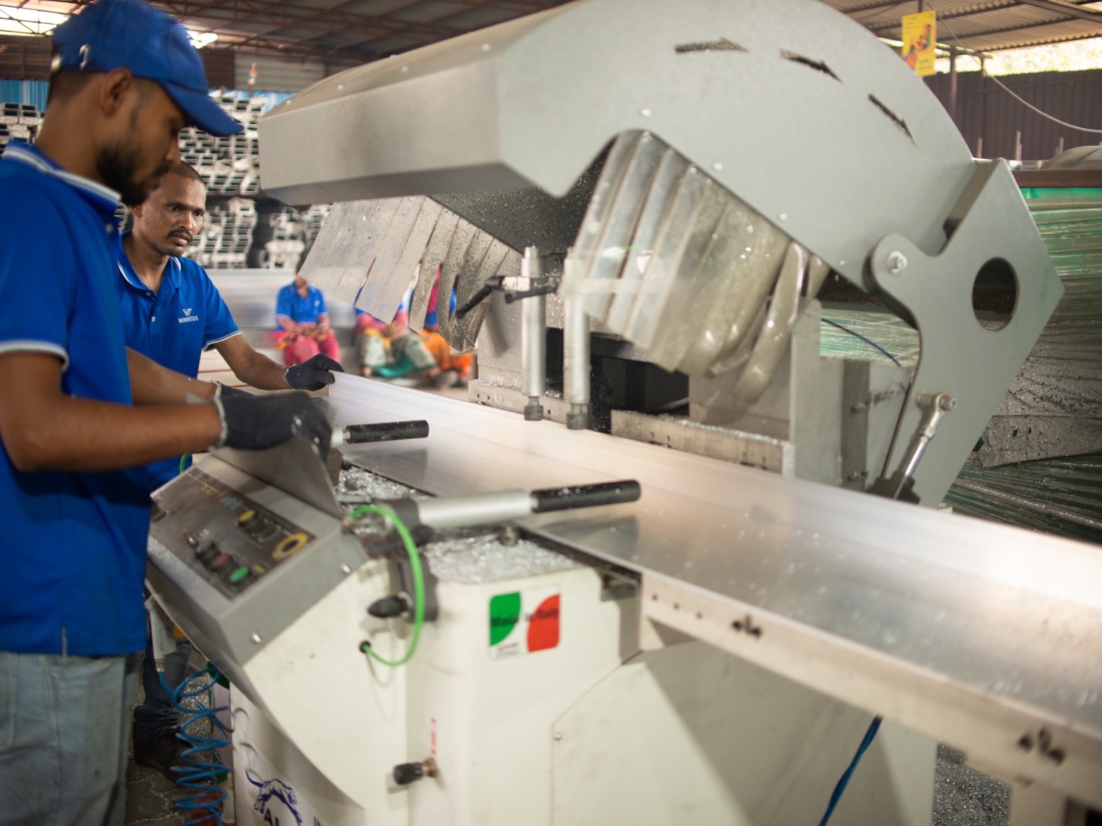 Two workers assembling components at a workshop bench