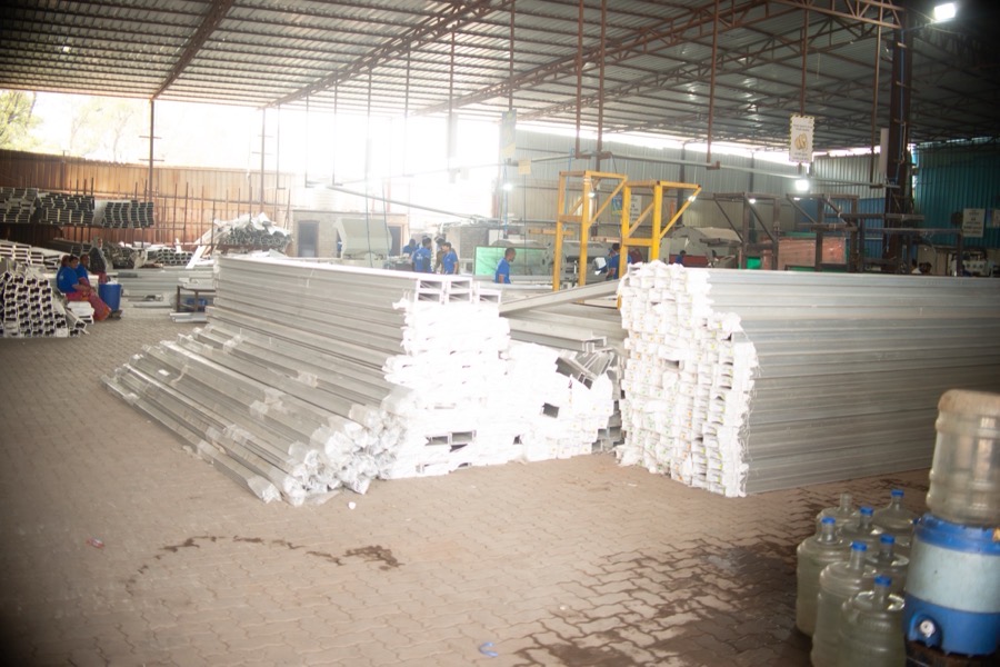 Racks and floor rows of aluminium formwork components in the factory store